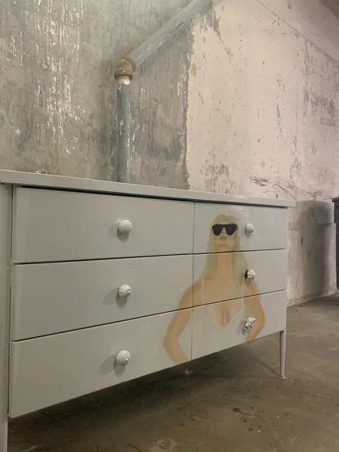 I used to paint furniture I found on the street. On this dresser, I painted a blonde figure in sunglasses across the drawers.