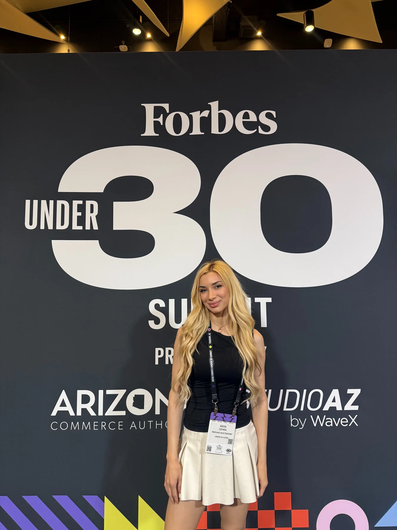 Anya Ozmen in front of the Forbes 30 Under 30 Summit backdrop